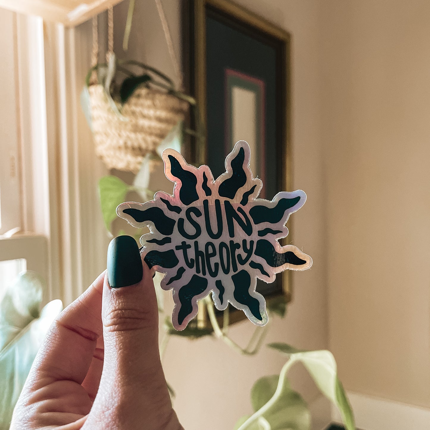 hand holding holographic sun theory sticker