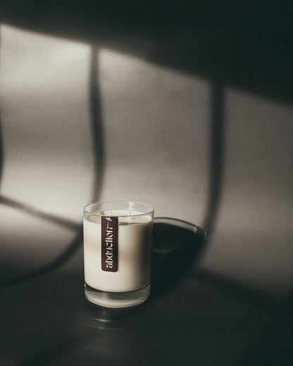 Candle with a label in a dark setting