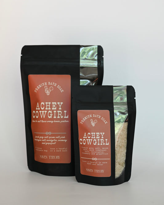 Two black bags with 'Achey Cowgirl' branding on a white background