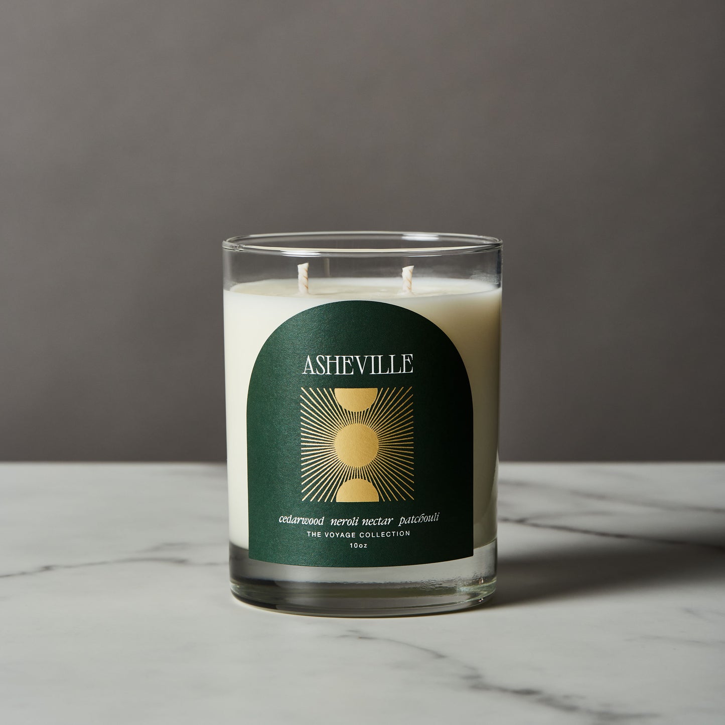 Asheville Candle with a green label on a gray background
