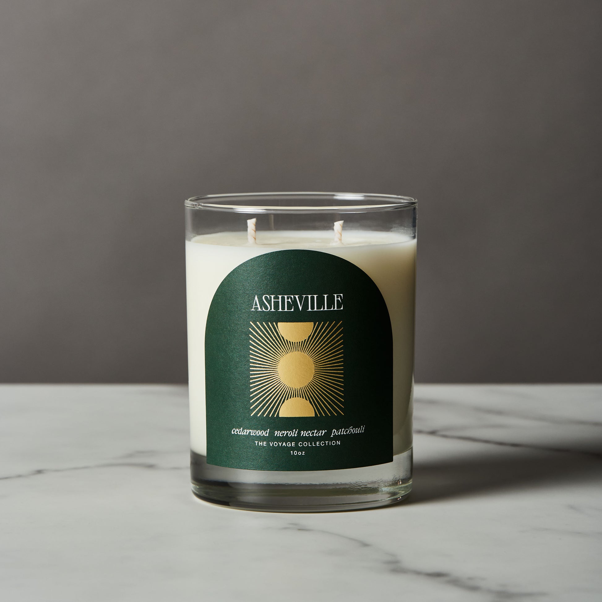 Asheville Candle with a green label on a gray background