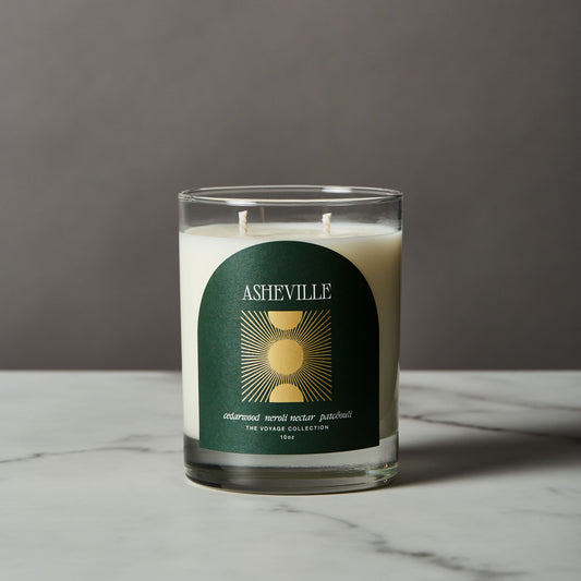 Asheville Candle with a green label on a gray background