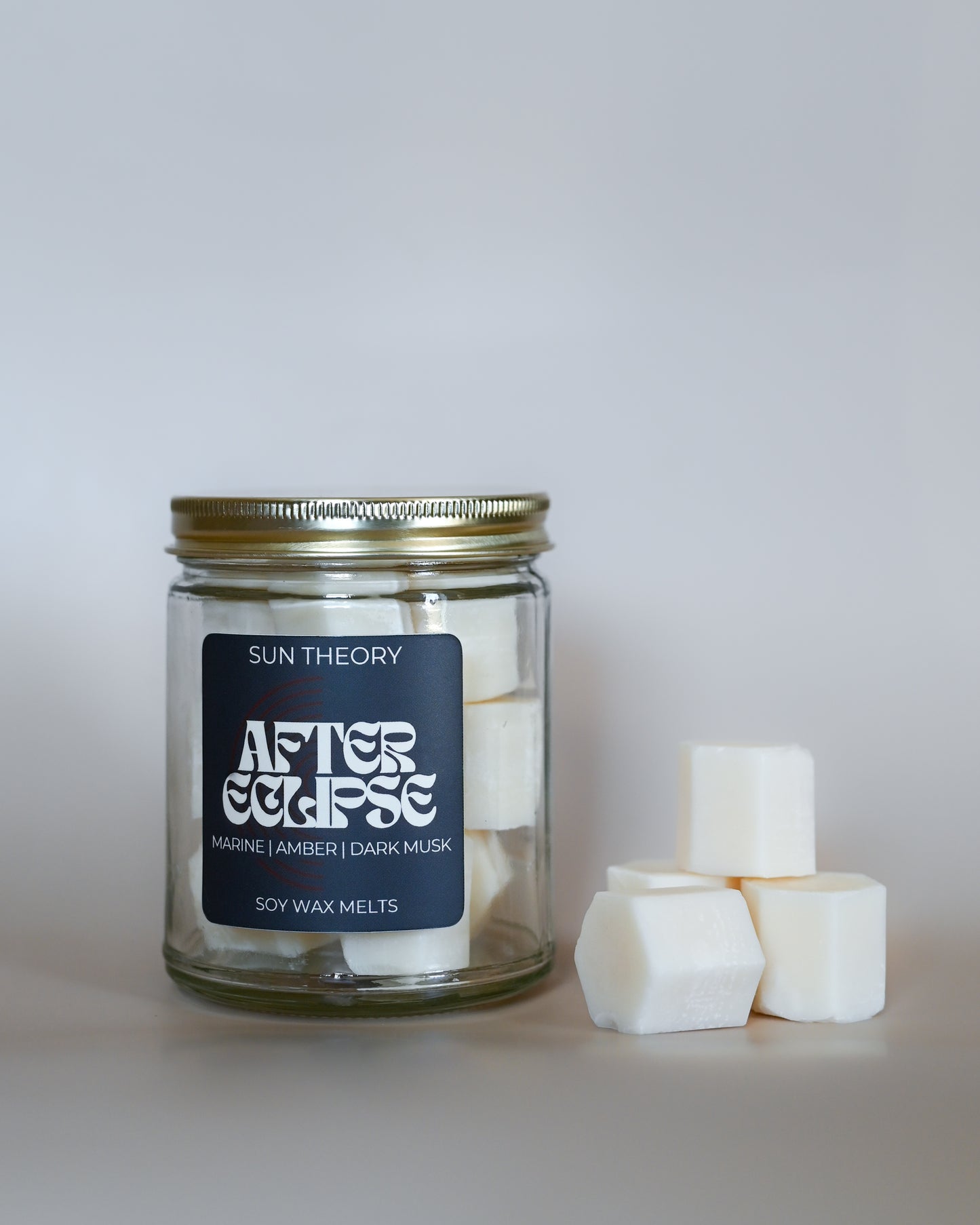 Jar of Sun Theory After Eclipse soy wax melts on a light gray background