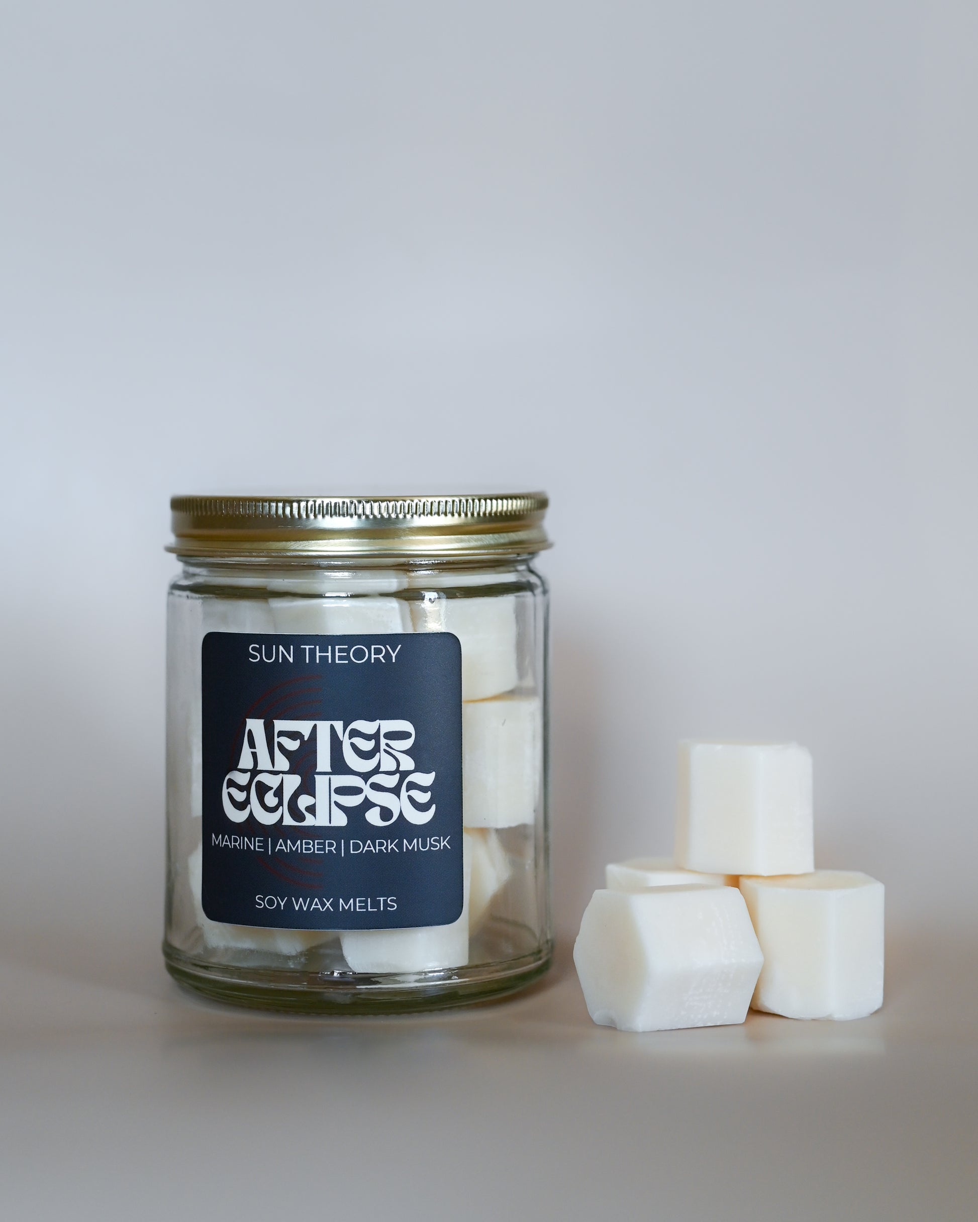 Jar of Sun Theory After Eclipse soy wax melts on a light gray background