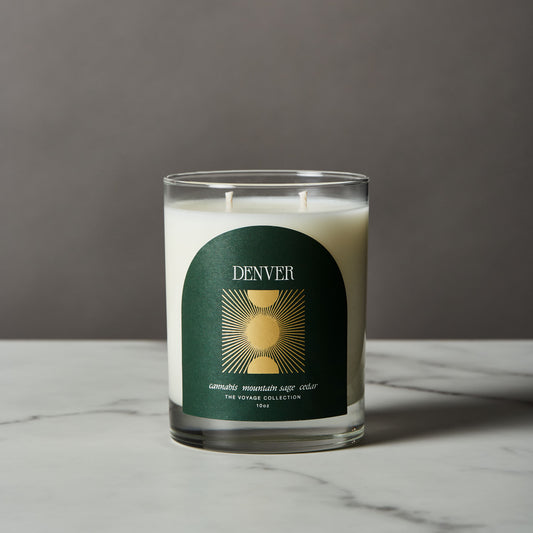 Candle with a 'Denver' label on a gray background