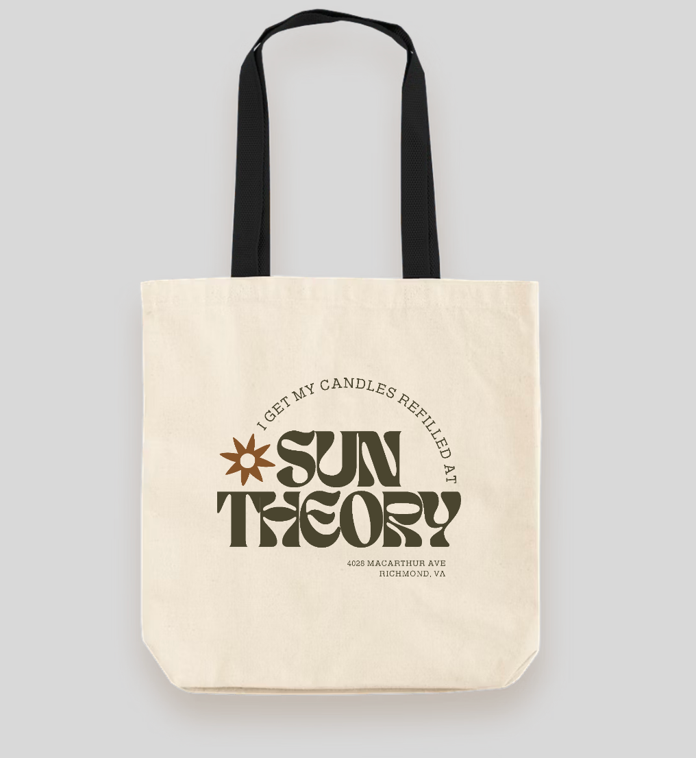 Tote bag with 'I get my candles refilled at Sun Theory' branding on a light gray background