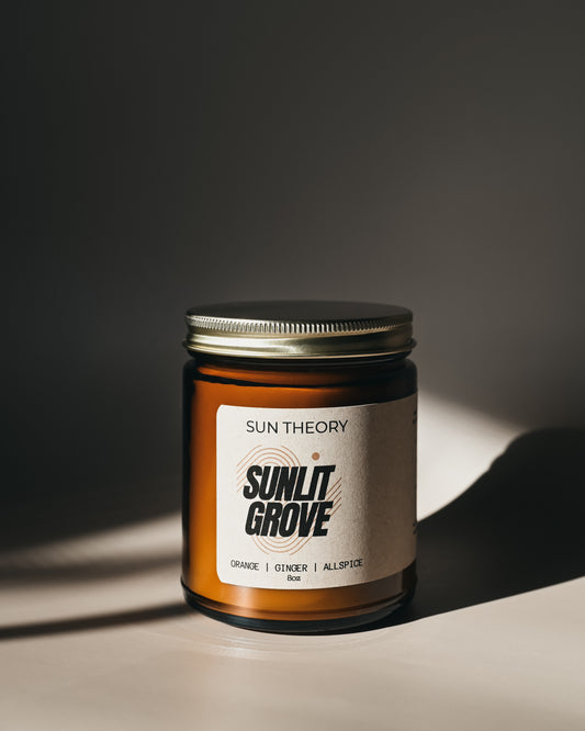 Sun Theory Sunlit Grove candle on a dark background