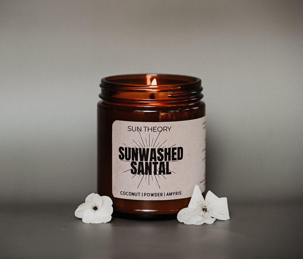 Sunwashed Santal candle with a label on a gray background