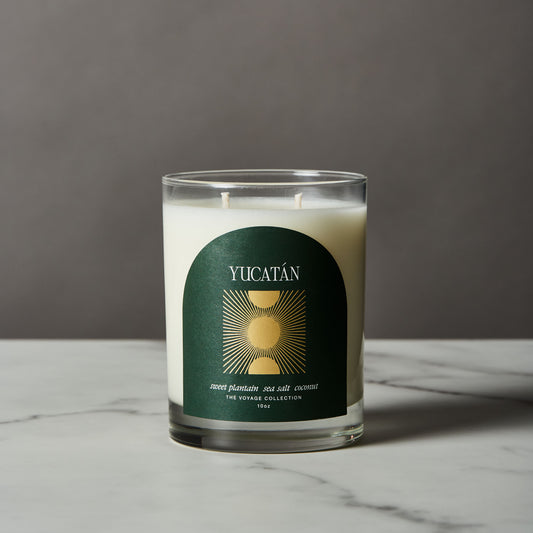 Yucatan candle with a green label on a marble surface