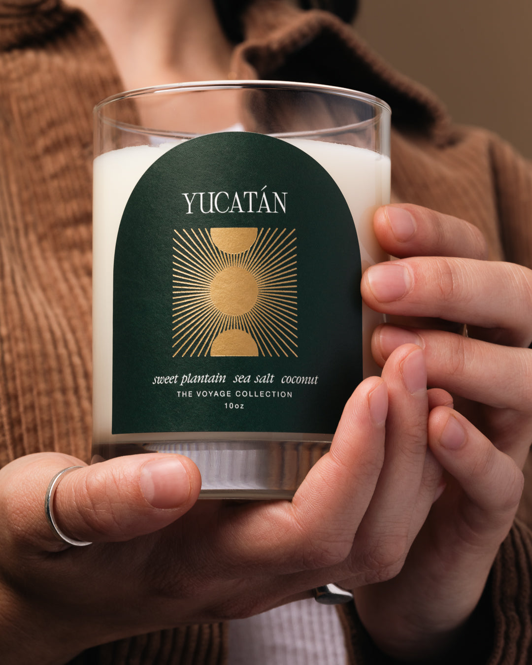 Candle with Yucatan label held by a person