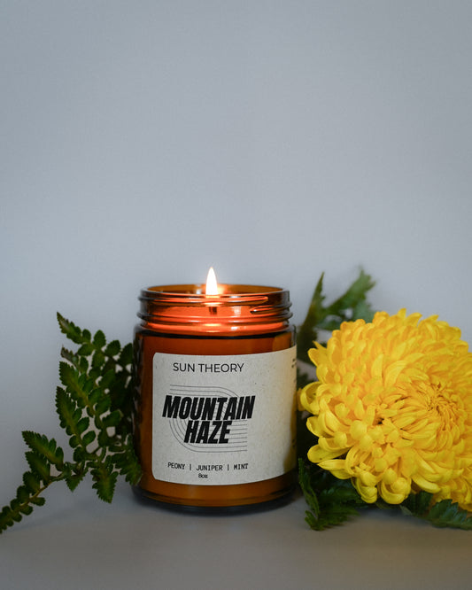 Mountain Haze soy candle in an amber colored glass vessel