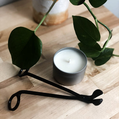 Matte Black Wick Trimmer on table next to candle