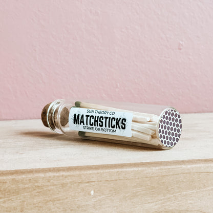 glass jar of matchsticks laying on its side