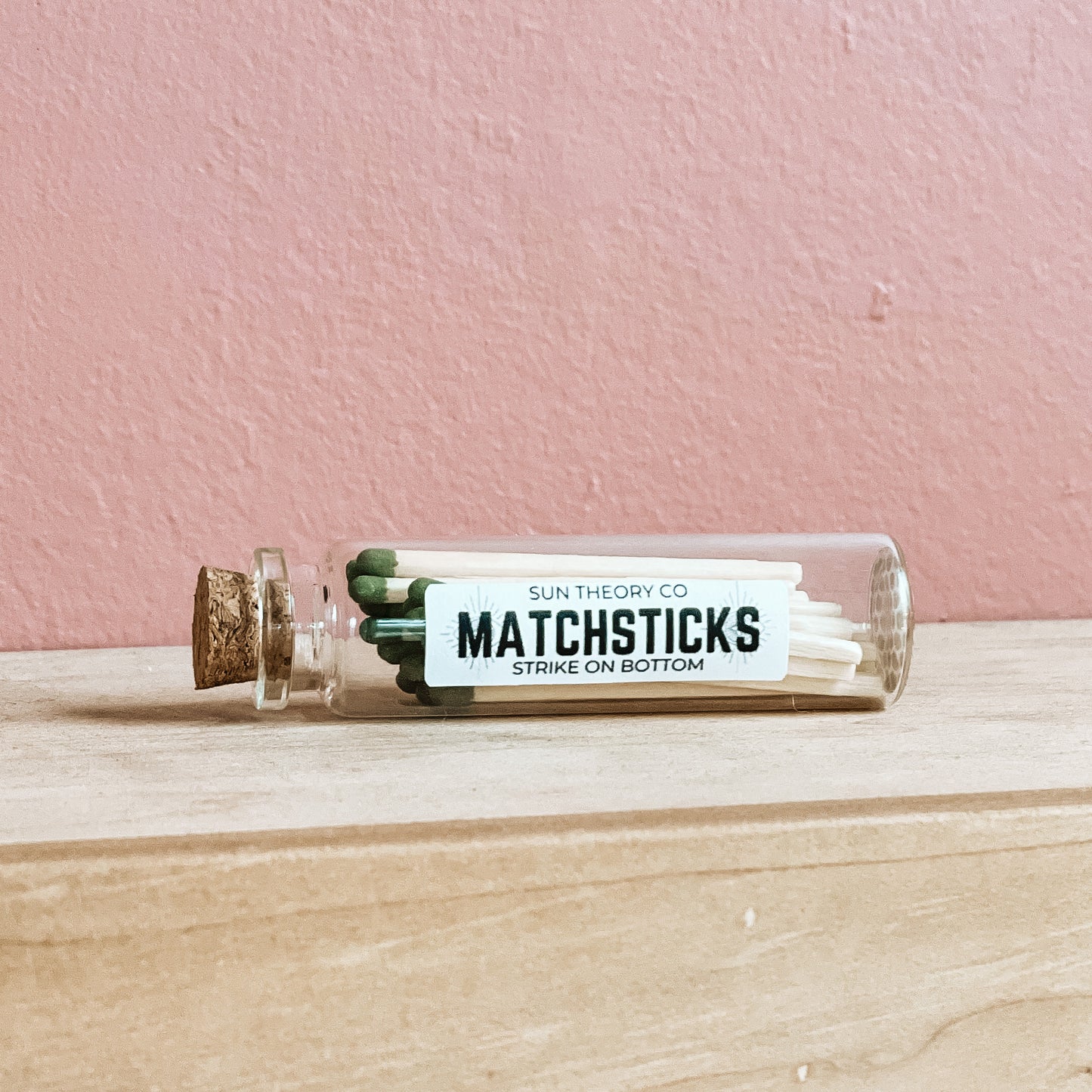 Glass jar of matchsticks laying on its side